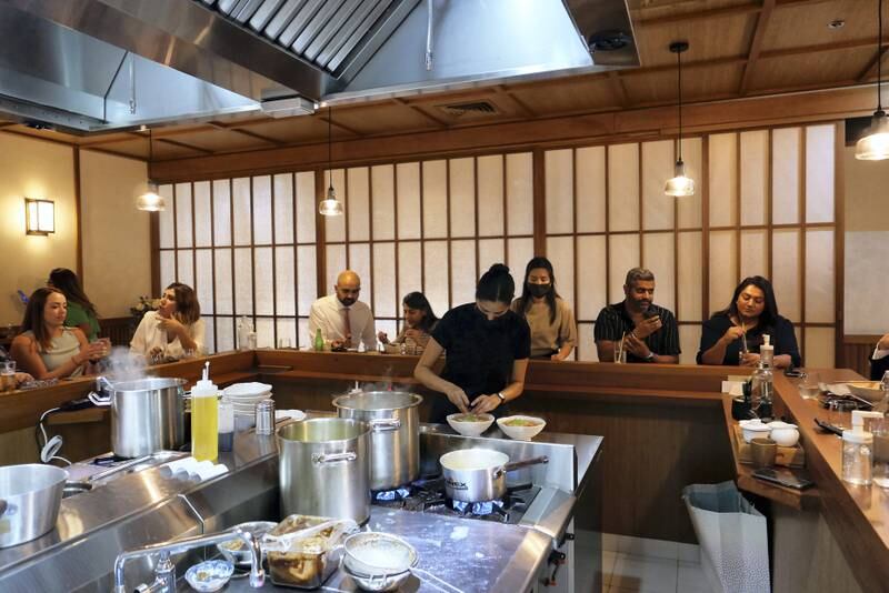 The restaurant has a ramen counter, an open seating area, a bar, a chef’s table and two tatami rooms.