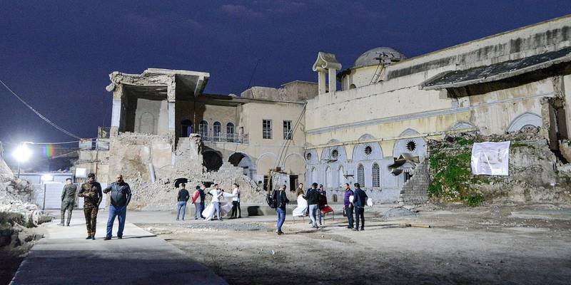 Volunteers finalise preparations to recieve Pope Francis in the ruins of the Syriac Catholic Church of the Immaculate Conception (al-Tahira) in the old city of Iraq's northern city of Mosul ahead of the pontiff's visit later in the week.  AFP