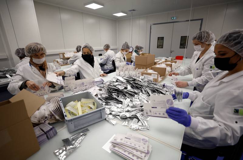 Employees work on the assembly line to produce self-testing kits at the NG Biotech factory in Guipry-Messac as France experiences a surge in Covid-19 cases due to the Omicron variant.  Reuters
