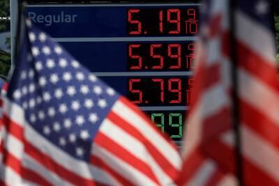 Petrol prices are displayed at an Exxon gas station behind American flag in Edgewater, New Jersey. Reuters