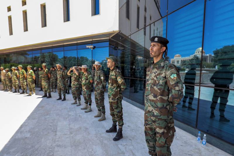 Fighters loyal to Libya's Tripoli-based Government of National Unity stand guard outside the headquarters of Libya's National Oil Corporation in the capital after the removal of its chairman, Mustafa Sanalla. AFP