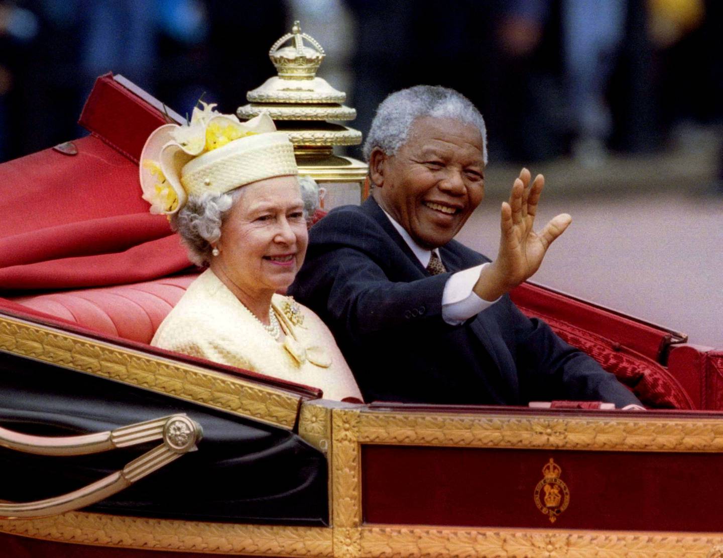 Nelson Mandela, the then president of South Africa, rides in a horse-drawn carriage with Queen Elizabeth II in London during a state visit in 1996. Reuters 

