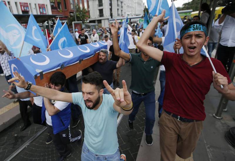 Uighurs living in Turkey and their supporters, some carrying coffins representing Uighurs who died in China's far-western Xinjiang region, chant slogans as they stage a protest in Istanbul on July 4, 2015. Emrah Gurel/AP Photo