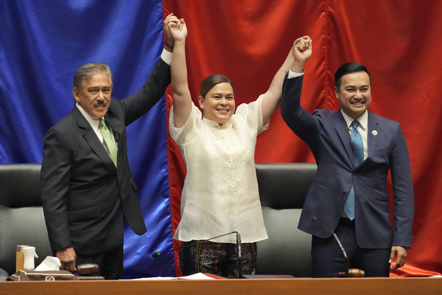 Sara Duterte celebrates with Senate President Vicente Sotto III, left, and House Speaker Lord Allan Velasco after being proclaimed Vice President on Wednesday. AP