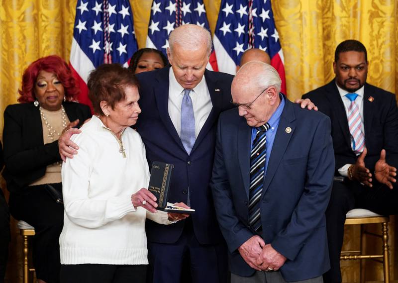 Mr Biden embraces the parents of Officer Sicknick as he presents presents them with his posthumous medal. Reuters