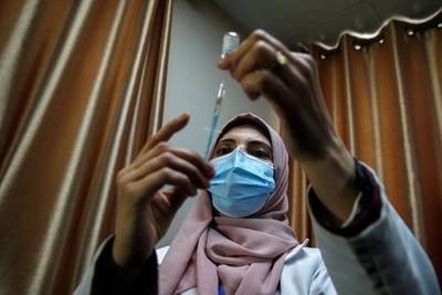 A health worker fills a syringe with the Covid-19 vaccine in Gaza city. Reuters