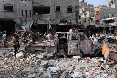 Wrecked vehicles and rubble on the streets following Israeli strikes on Al Shatee camp in Gaza city. AFP