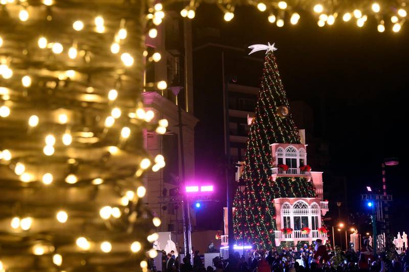 Lebanese people gather next to a giant Christmas tree which has been officially lit up at the Ashrafieh area in Beirut, Lebanon. The celebration comes amid the COVID-19 coronavirus pandemic and the country's severe economic crisis, which comes four months after the blast at Beirut port.  EPA