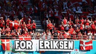 Denmark's supporters hold a banner in support of Denmark's midfielder Christian Eriksen. AFP