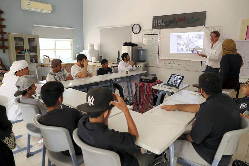 RAS AL KHAIMAH , UNITED ARAB EMIRATES , FEB 21  – 2018 :- Guy Brooksbank ( white shirt right side )  teaching students from Saeed Bin Jubair Secondary School how to take photograph during the photography workshop at the school campus in Ras Al Khaimah. ( Pawan Singh / The National ) For News. Story by Ruba Haza