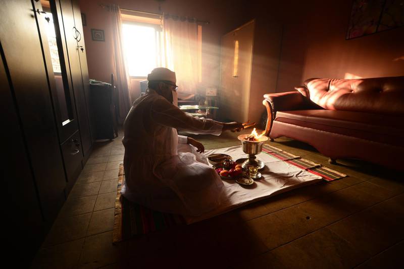 In Karachi, priest Berjise Bhada prepares a fire to begin the Jashan thanksgiving ceremony, practiced by those of the Zoroastrian faith. The fire is considered holy, and priests must cover their noses and mouths to prevent their breath from contaminating it. Mobeen Ansari