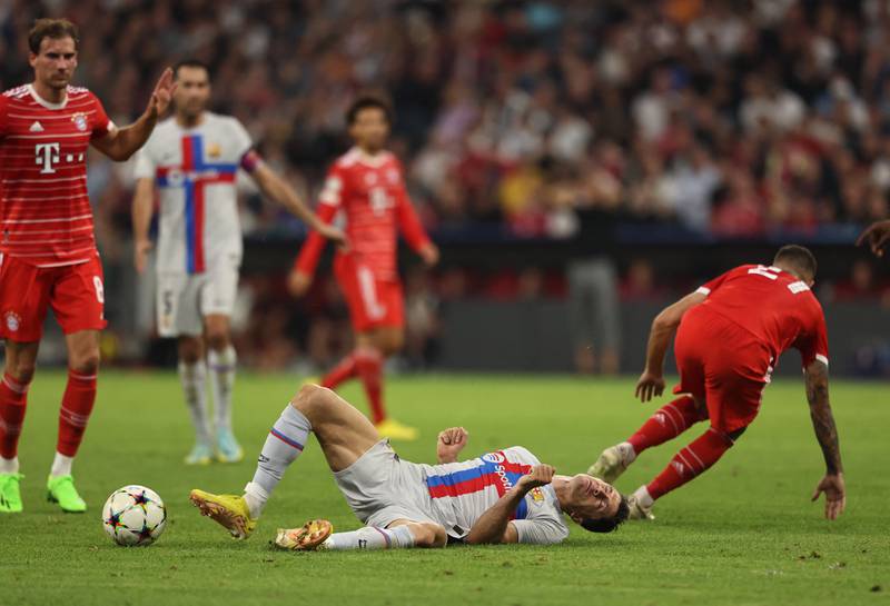 Robert Lewandowski in action with Bayern Munich's Lucas Hernandez. Reuters