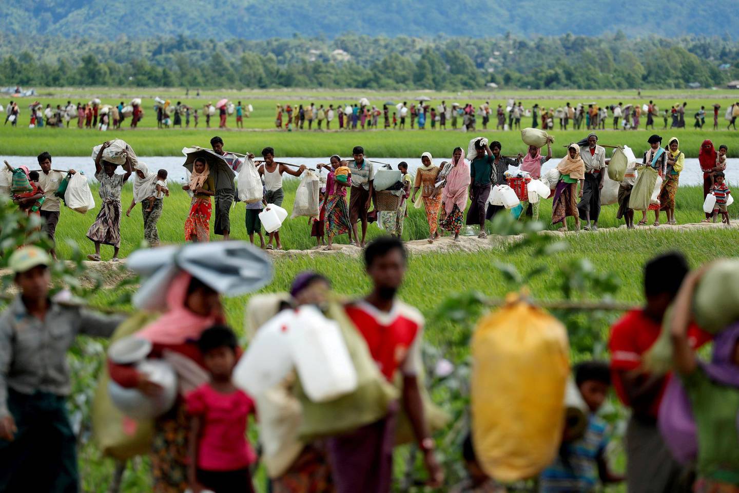 FILE PHOTO: Rohingya refugees, who crossed the border from Myanmar two days before, walk after they received permission from the Bangladeshi army to continue on to the refugee camps, in Palang Khali, near Cox's Bazar, Bangladesh October 19, 2017. To match Special Report MYANMAR-ROHINGYA/BATTALIONS     REUTERS/Jorge Silva/File Photo