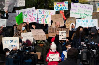 Parents and children gather in front of New York's City Hall to protest the closing of public schools. AP