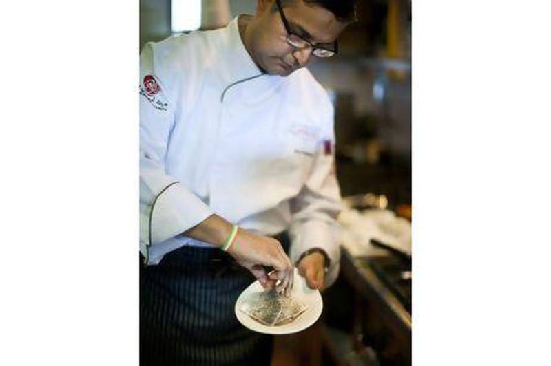 The Indian chef Atul Kochhar cooks a sea bream dish in Ushna's kitchen, in Abu Dhabi's Souk Qaryat al Beri.
