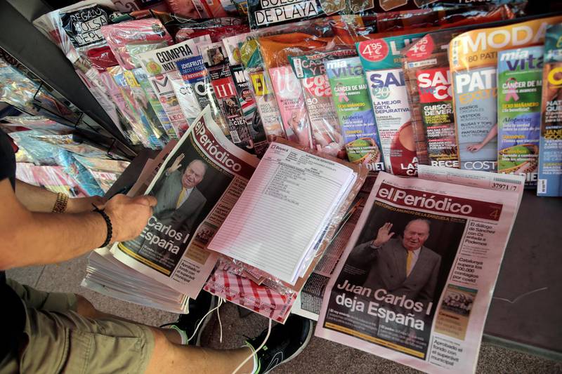 A man looks at the newspapers with news about Spain's former king Juan Carlos I, in Madrid, Spain August 4, 2020. REUTERS