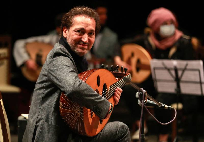 Iraqi musician Naseer Shamma plays the oud during rehearsals at the Iraqi National Theater in Baghdad on January 17, 2022.  - Long uprooted from his native Iraq, Shamma, an icon of the Arabic oud, has returned home to help rekindle the flame of Iraqi music, snuffed out by decades of conflict.  (Photo by AHMAD AL-RUBAYE  /  AFP)