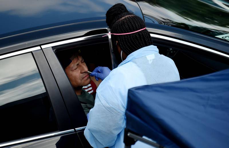 People get free Covid-19 tests without needing to show ID, doctor's note or symptoms, at a drive-through and walk up Coronavirus testing centre located at Barcroft Community Centre in the Arlington zip code with the highest concentration of Coronavirus cases, in Arlington, Virginia.
  AFP