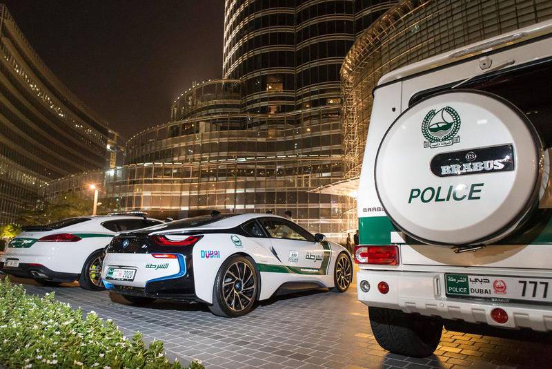 From left, a Porsche Panamera, BMW i8 hybrid sports car and a Brabus 700, all in the Dubai Police colours, pictured in 2015. Dubai Police