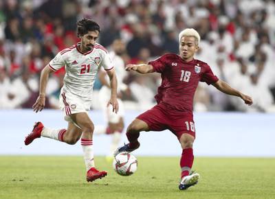 Al Ain, United Arab Emirates - January 14, 2019: Khalfan Mubarak of UAE and Chanathip Songkrasin of Thailand battle during the game between UAE and Thailand in the Asian Cup 2019. Monday, January 14th, 2019 at Hazza Bin Zayed Stadium, Al Ain. Chris Whiteoak/The National