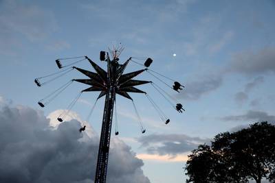 Fairgoers spin around on a carnival ride during the Miami-Dade County Fair & Exposition in Miami, Florida. EPA