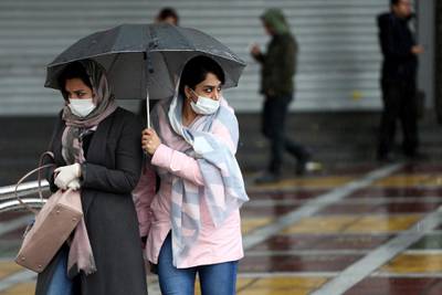 FILE PHOTO: Iranian women wear protective masks to prevent contracting coronavirus, as they walk in the street in Tehran, Iran February 25, 2020. WANA (West Asia News Agency)/Nazanin Tabatabaee via REUTERS ATTENTION EDITORS - THIS IMAGE HAS BEEN SUPPLIED BY A THIRD PARTY/File Photo