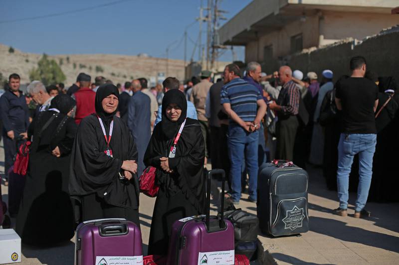 Syrians gather at the border crossing as they prepare to travel to Makkah. AFP