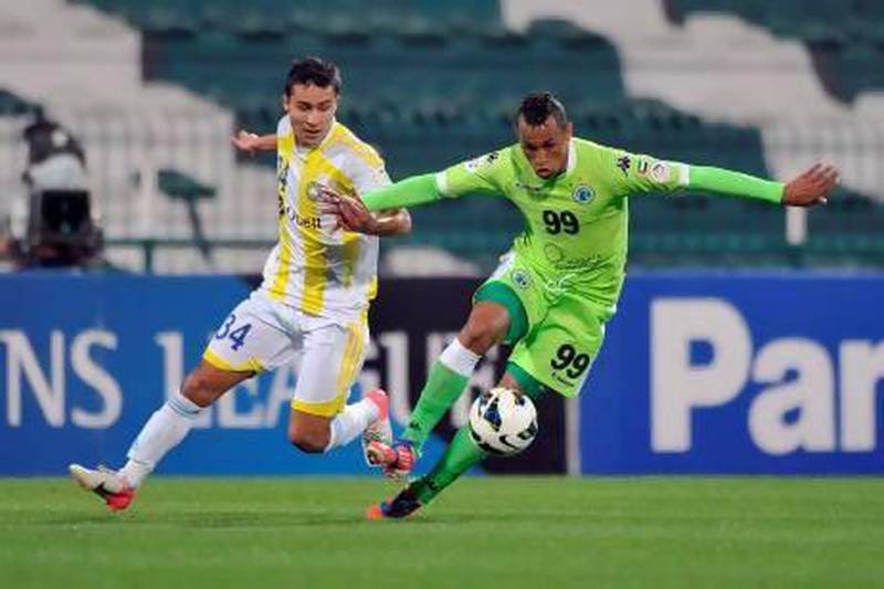 Ciel (green) of Shabab controls the ball during the Asian Championship League match against Pakhtakor (Uzebkistan) (white/yellow) in Dubai on Tuesday, March 12, 2013. (Ashraf Umrah / Ittihad)