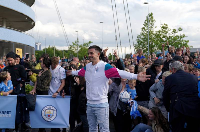 Jack Grealish poses with Manchester City fans.