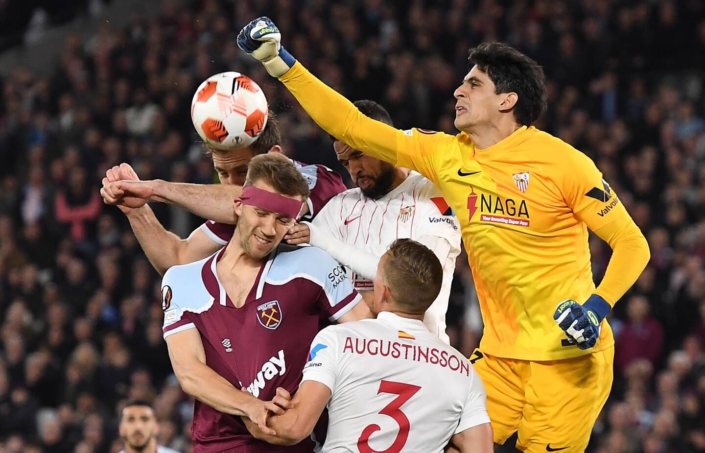 Sevilla goalkeeper Yassine Bounou attempts to punch clear during the Europa League last-16, second leg against West Ham United, in March 2022.   EPA