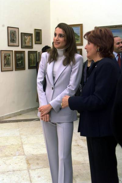 397925 01: Queen Rania talks to Jordanian artist Hind Nasser during the opening of Nasser's exhibition "The world around us" November 29, 2001 in Amman. The exhibition contains more than 100 paintings about Jordan. (Photo by Salah Malkawi/Getty Images)