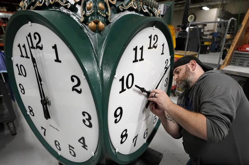 Clock technician Dan LaMoore adjusts the hands on a large outdoor clock under construction in US city of Woonsocket, Rhode Island. AP