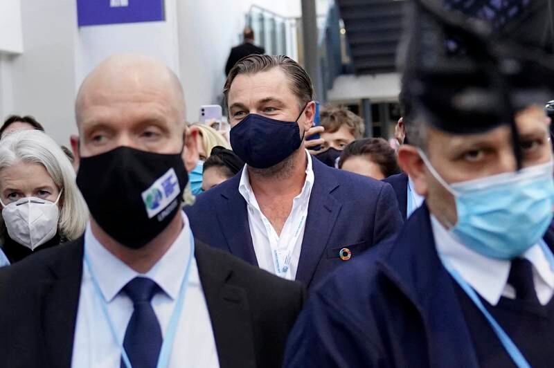 The Hollywood star, 46, was pictured at the conference surrounded by an entourage and wearing a blue suit featuring a colourful lapel pin. AP