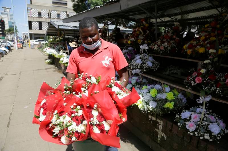 A vendor holds flowers in Harare, Zimbabwe. EPA