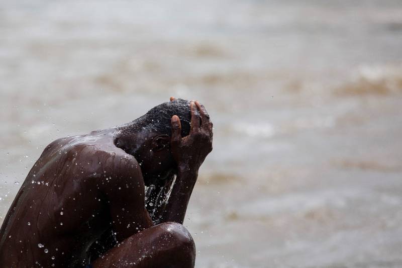 A man cools off in a river along with other migrants in Huixtla. Reuters