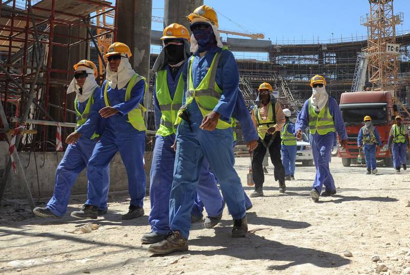 Foreign workers leaving a construction site in Doha, Qatar. Amnesty released a report on November 12 urging the country to speed up its reforms on labour. EPA