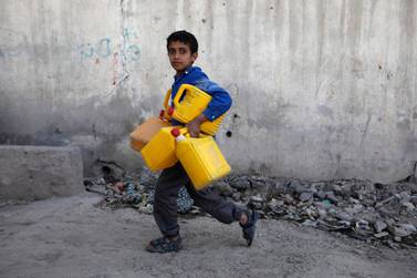 A boy carries cans to fill with drinking water from a water pipe in Sanaa, Yemen. EPA