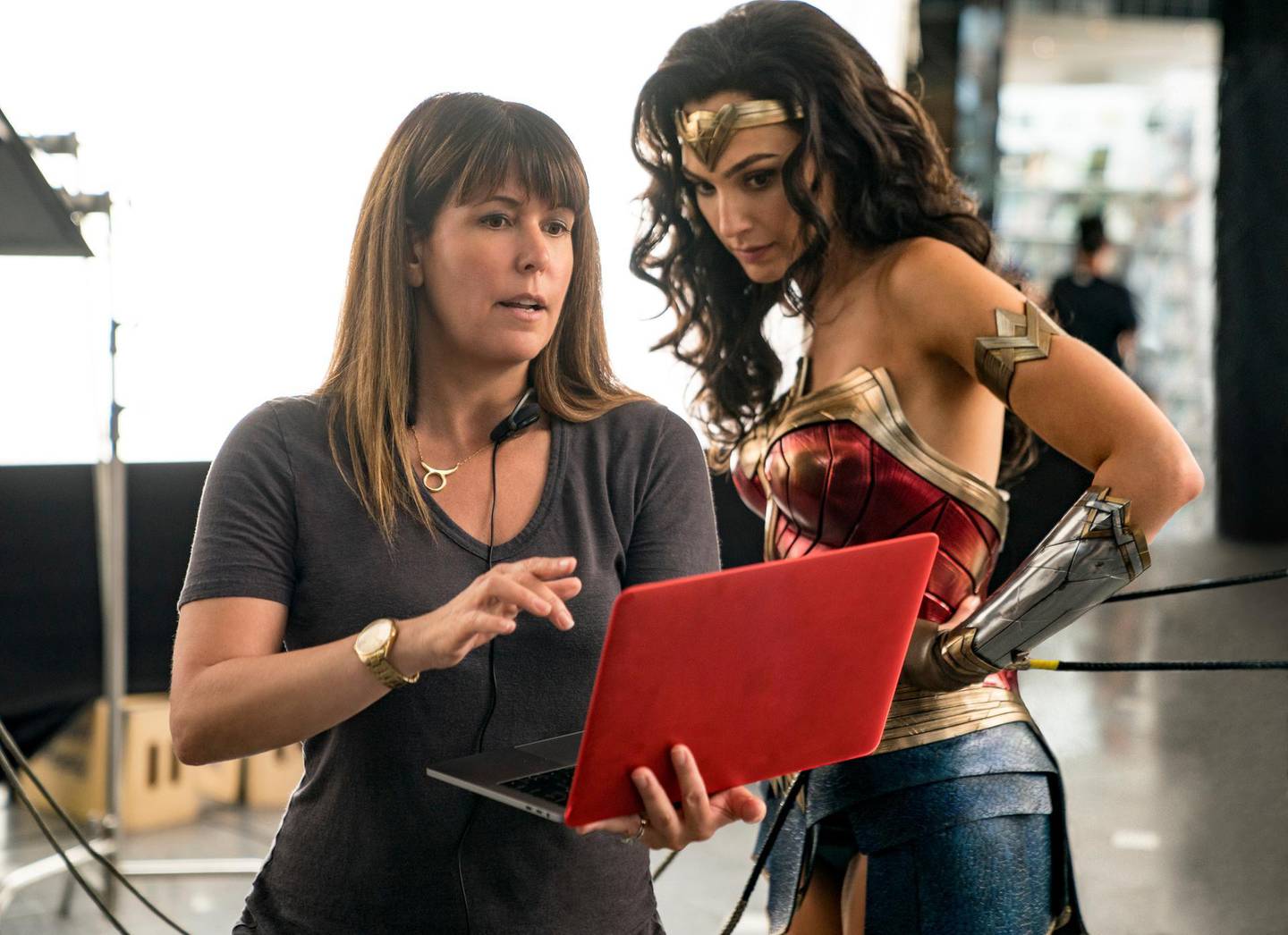 This image released by Warner Bros. Entertainment shows director Patty Jenkins, left, with actress Gal Gadot on the set of "Wonder Woman 1984." (Clay Enos/Warner Bros. Entertainment via AP)