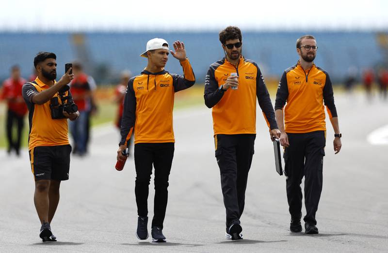 McLaren's Lando Norris walks with his team ahead. Reuters