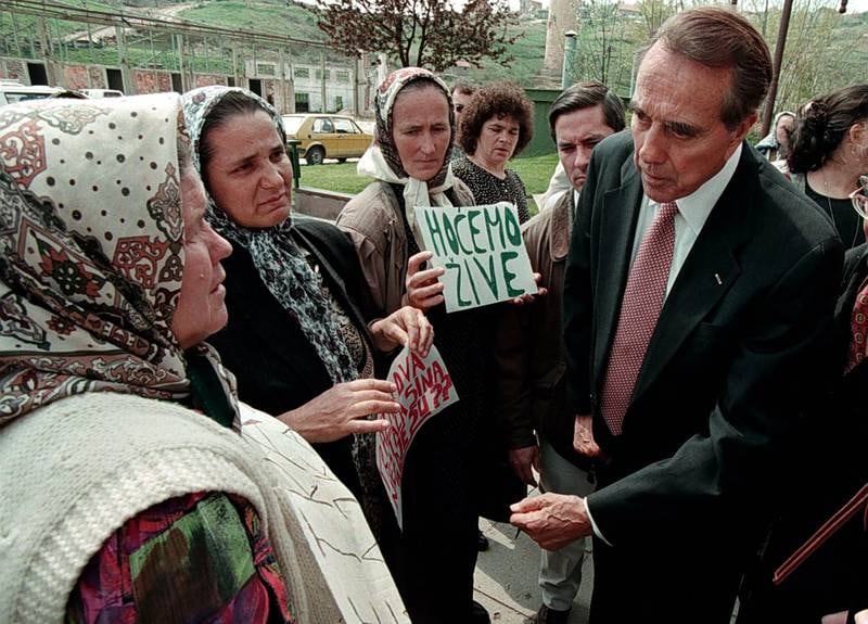 Dole talks to women at Srebrenica on a weekend visit to Bosnia and Herzegovina in April 1998, in his capacity as chairman of the International Commission on Missing Persons. EPA