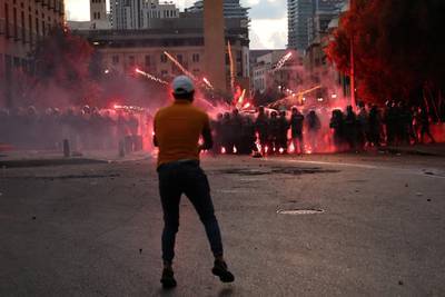 A demonstrator throws fireworks at riot police during anti-government protests that have been ignited by a massive explosion in Beirut, Lebanon, August 10, 2020. REUTERS/Alkis Konstantinidis