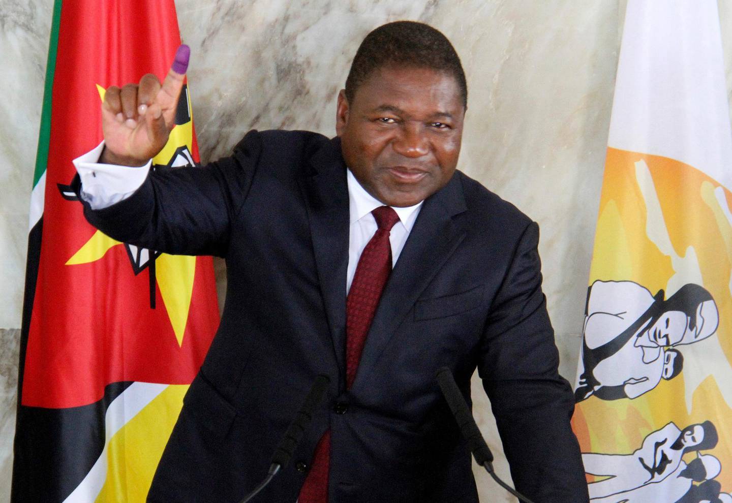 FILE - In this Tuesday, Oct. 15, 2019 file photo, Mozambican President Felipe Nyusi poses at a polling station where he cast his vote in Maputo. Nyusi is to be sworn in Wednesday, Jan. 15, 2020 for a second and final term in Maputo after five turbulent years in office and facing two armed insurgencies as well as economic opportunities. (AP Photo/Ferhat Momade/File)
