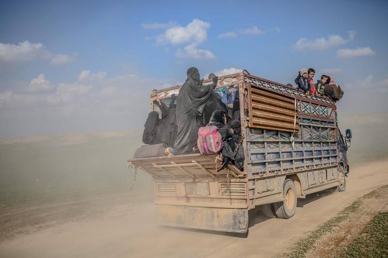 TOPSHOT - This picture taken on February 22, 2019 shows a convoy of trucks transporting people who fled the Islamic State (IS) group's last holdout of Baghouz in Syria's northern Deir Ezzor province.  / AFP / Bulent KILIC
