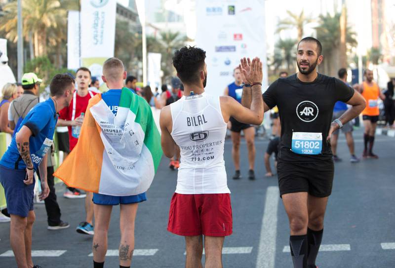 Dubai, United Arab Emirates - Participants at the finish line at the Dubai 30x30 Run at Sheikh Zayed Road.  Leslie Pableo for The National