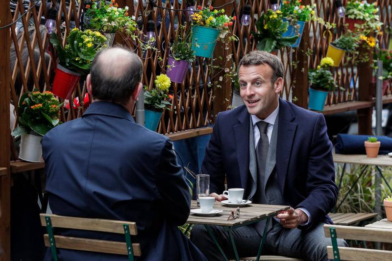 French President Emmanuel Macron and French Prime Minister Jean Castex have coffees at a cafe terrace in Paris, as restaurant and cafe terraces reopen at 50-percent capacity. AFP