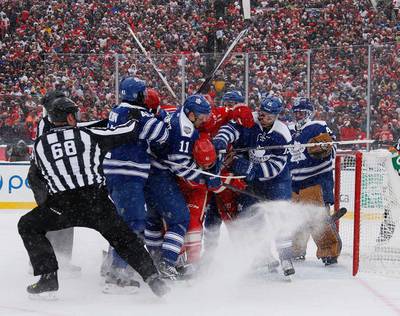 A mad scramble in front of Jonathan Bernier #45 of the Toronto Maple Leafs leads to a snow storm in the second period during the NHL Winter Classic at Michigan Stadium on Wednesday in Ann Arbor, Michigan. Gregory Shamus/Getty Images