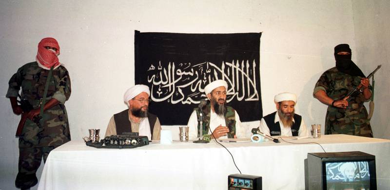 Armed masked men stand guard as bin Laden and Al Zawahiri address a news conference in May 1998 in Afghanistan. Getty