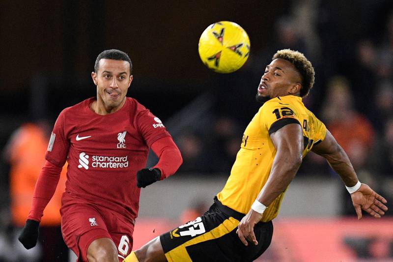 Wolves midfielder Adama Traore battles for the ball with Liverpool's Thiago Alcantara. AFP