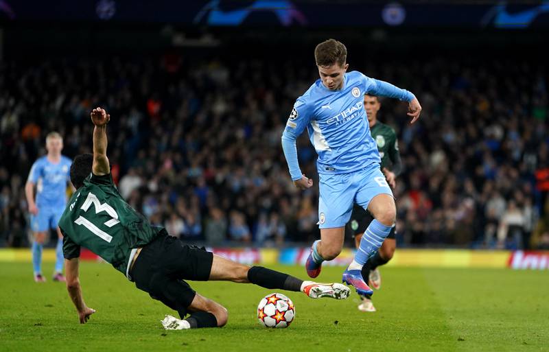 Manchester City's James McAtee battles with Sporting Lisbon's Luis Neto in the Uefa Champions League Round of 16 second leg at the Etihad. PA