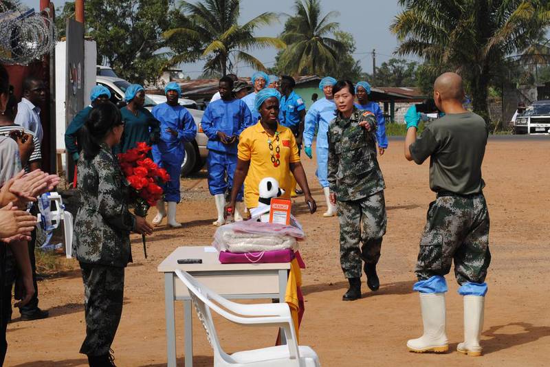 Liberia’s last known Ebola patient, Beatrice Yardolo, in yellow, arrives for a ceremony at the Chinese Ebola treatment unit where she was treated. Liberia has suffered the most deaths since the virus broke out, accounting for more than 4,000 of the 10,000 deaths registered across African countries. James Giahyue / Reuters